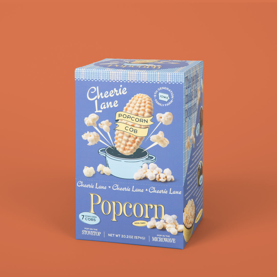 Cheerie Lane popcorn box on an orange background