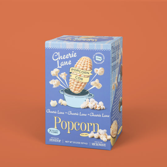 Cheerie Lane popcorn box on an orange background