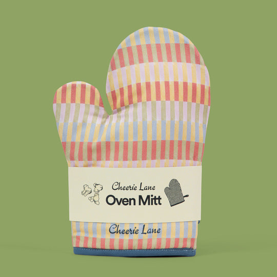 Colorful striped oven mitt with 'Cheerie Lane' branding on a green background
