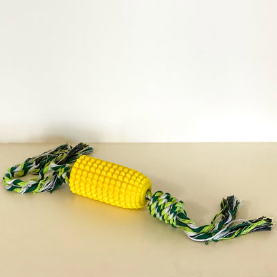 Yellow rubber corn cob dog toy with green rope